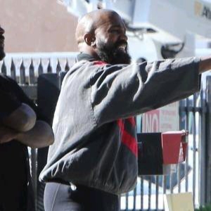 Kanye West looks unrecognizable with a big smile, full beard…